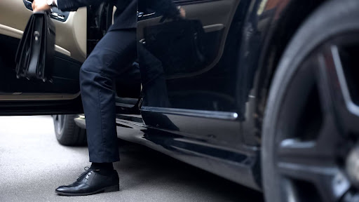 Man stepping out of executive taxi